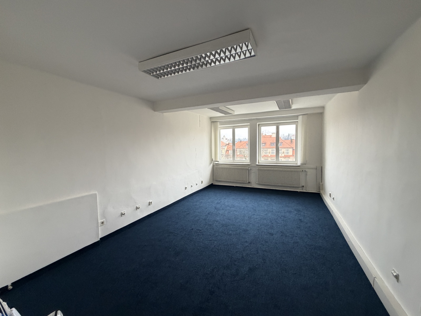 Spacious office with a view of Klementinum's red rooftops